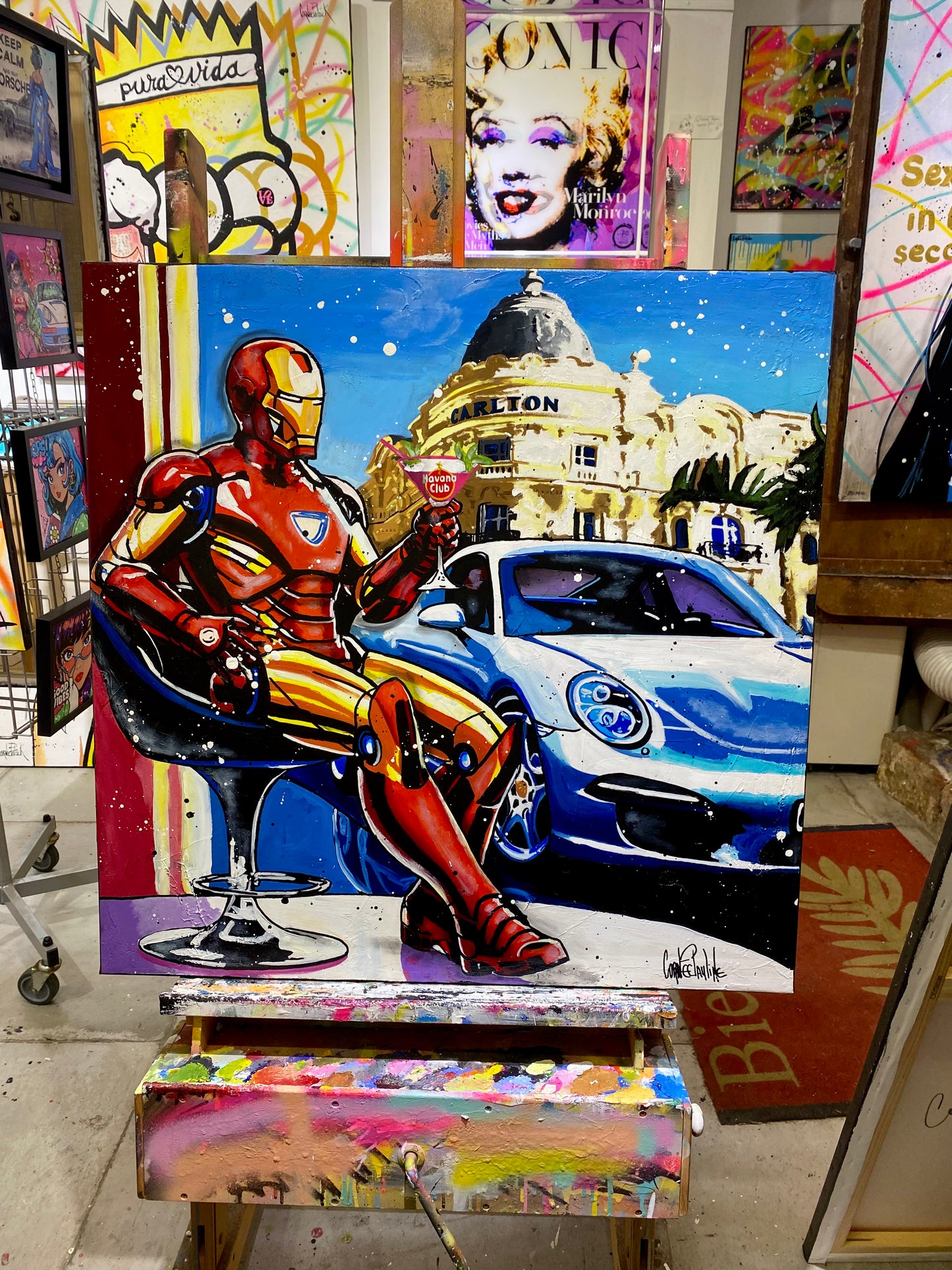 Iron Man enjoys a cocktail next to Porsche