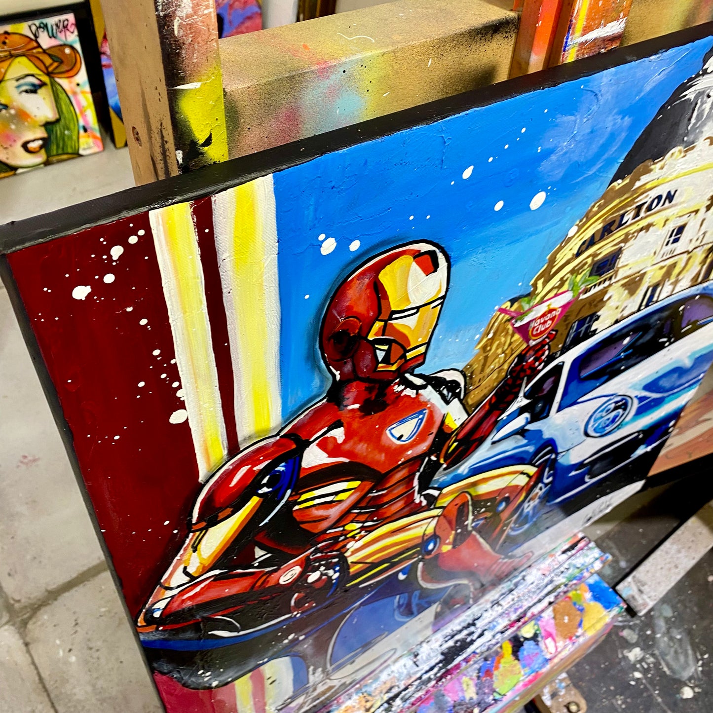 Iron Man enjoys a cocktail next to Porsche